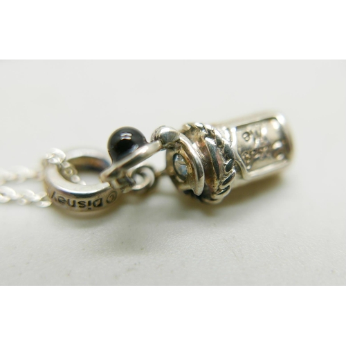 1028 - A silver Chamilia necklace with a silver Disney Alice in Wonderland 'Drink me' charm, together with ... 