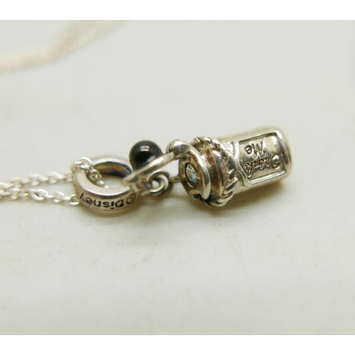 1028 - A silver Chamilia necklace with a silver Disney Alice in Wonderland 'Drink me' charm, together with ... 