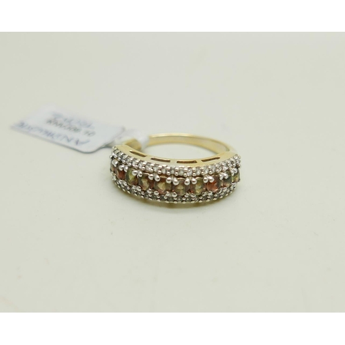 1032 - A silver gilt andalusite and topaz three row ring, U