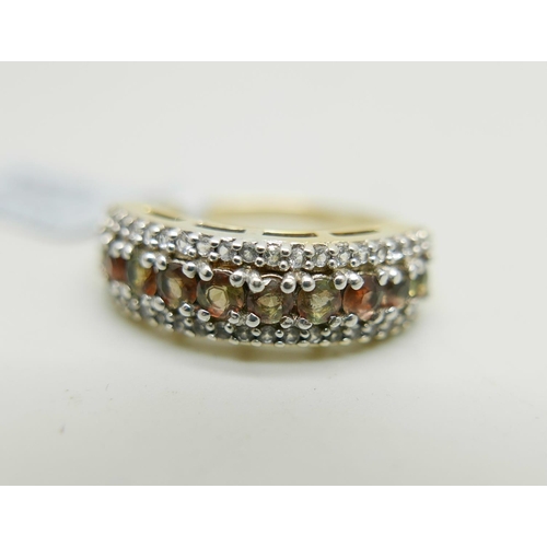 1032 - A silver gilt andalusite and topaz three row ring, U