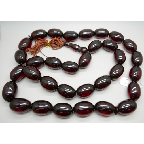 1033 - A large cherry coloured bead necklace, beads approximately 3cm x 4cm, 140cm