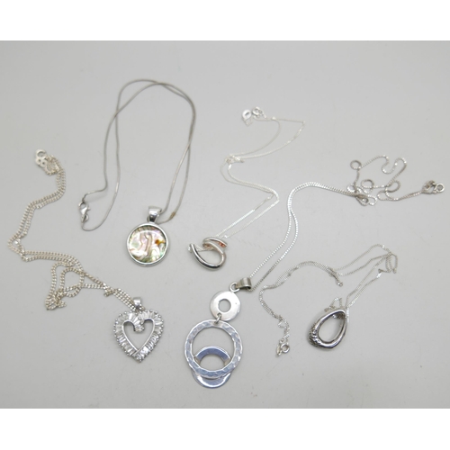 1034 - Five silver pendants and chains, 39g