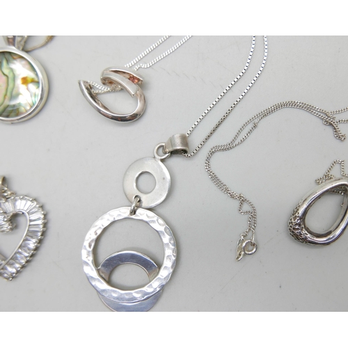 1034 - Five silver pendants and chains, 39g