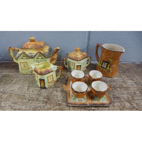 1038 - Three pieces of Keele St. pottery, a teapot, and a jug and sugar bowl, two pieces of Price Bros cott... 