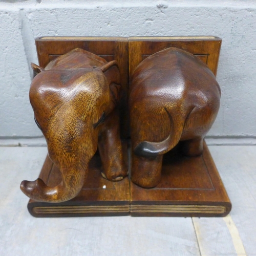 1053 - Two pairs of carved bookends in the form of elephants, a wooden globe, and a carved wooden cat **PLE... 