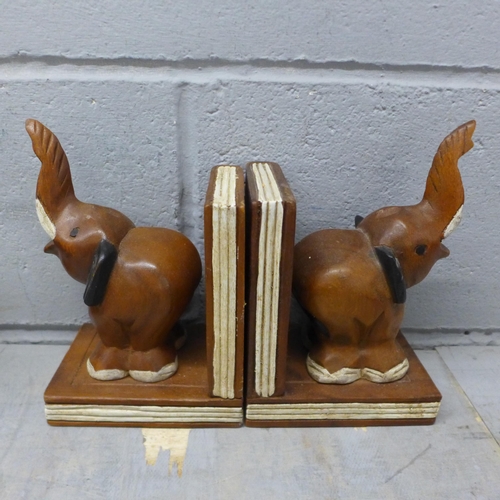 1053 - Two pairs of carved bookends in the form of elephants, a wooden globe, and a carved wooden cat **PLE... 