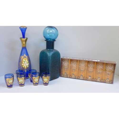 654 - An Empoli ribbed textured Genie teal decanter, Bohemian cobalt blue glass cordial decanter and six s... 