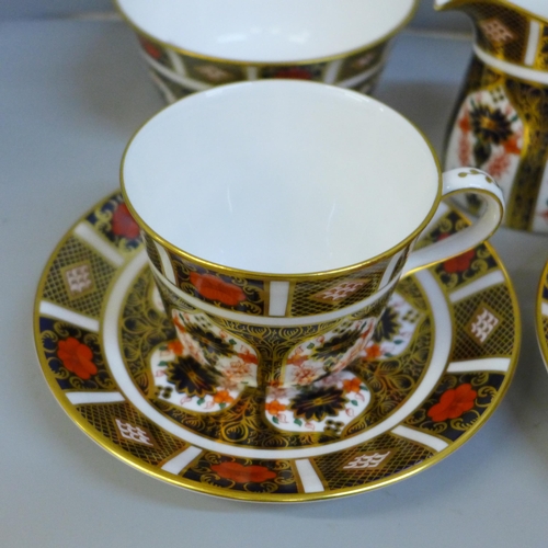 689 - A Royal Crown Derby 1128 Imari tea set - four cups and saucers, a milk jug, (second) a sugar bowl an... 