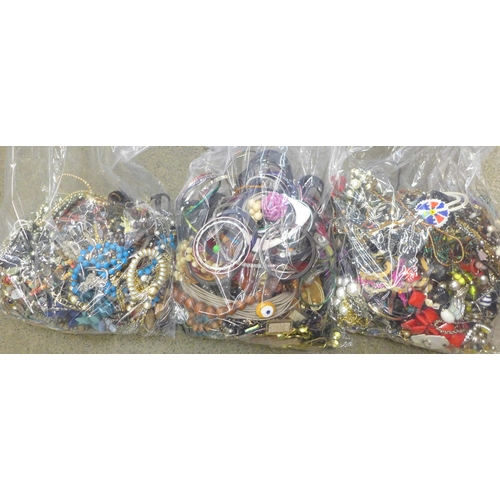 704 - Three large bags of costume jewellery