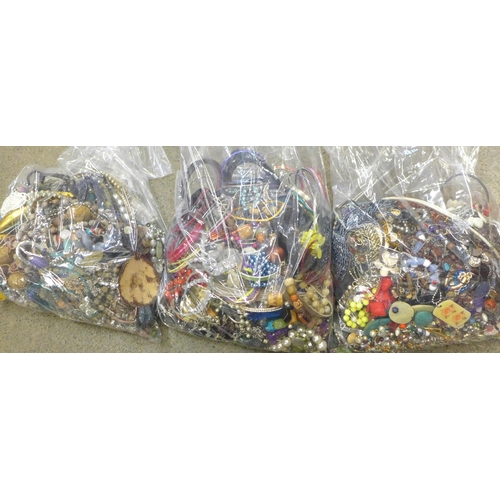 704 - Three large bags of costume jewellery