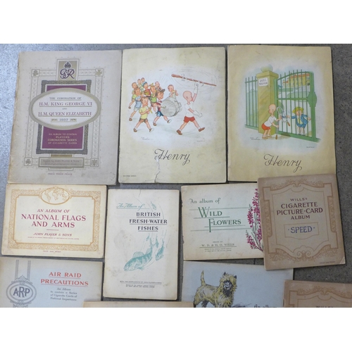 744 - A collection of cigarette cards including two albums of Henry, plus John Player and Wills, complete ... 