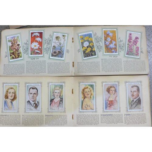 744 - A collection of cigarette cards including two albums of Henry, plus John Player and Wills, complete ... 