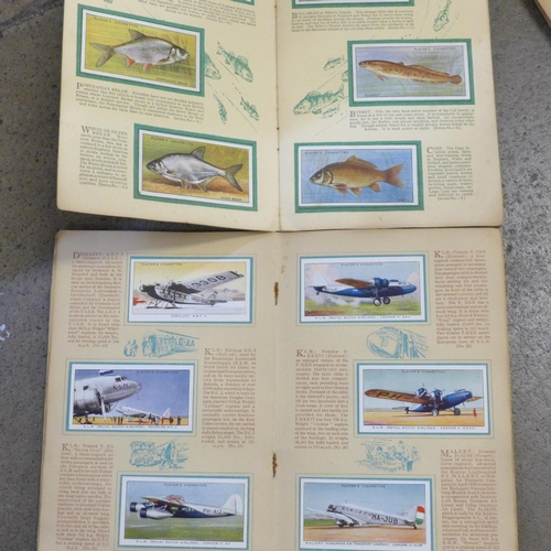 744 - A collection of cigarette cards including two albums of Henry, plus John Player and Wills, complete ... 