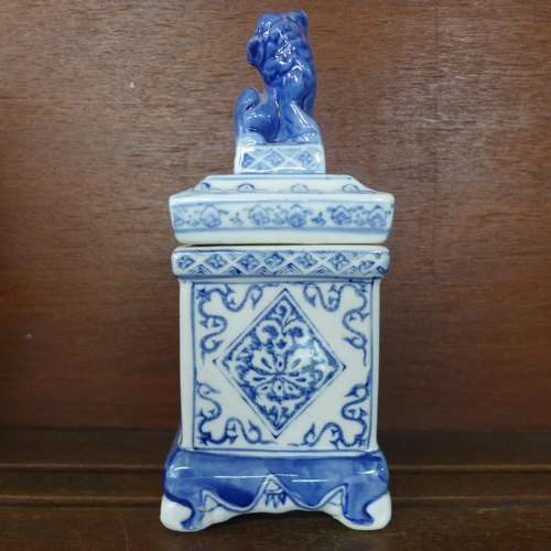 763 - A Chinese blue and white lion lidded opium jar, a Chinese blue and white square alter vase and a Chi... 