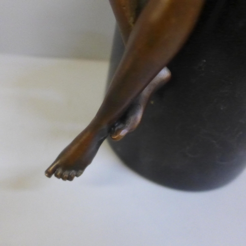 764 - After Jean Patoue, a bronze nude on a black marble plinth, 26.5cm