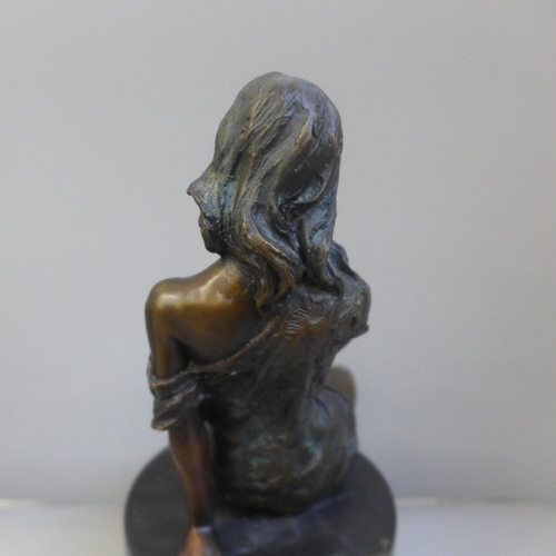 764 - After Jean Patoue, a bronze nude on a black marble plinth, 26.5cm