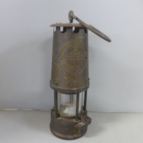 772 - An Eccles miner's lamp, W.E Teale Swinton Lancs lamp, miniature lamp and one other