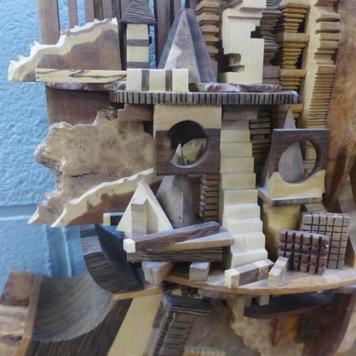 776 - Two large hand made carved and glued models of ships, largest 54cm wide