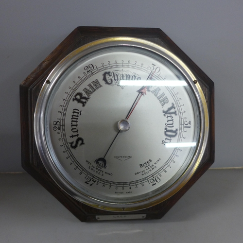 779 - An oak cased barometer with LNER long service award