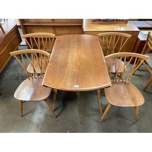 27 - An Ercol Blonde elm and beech Windsor drop-leaf table and four candlestick back chairs