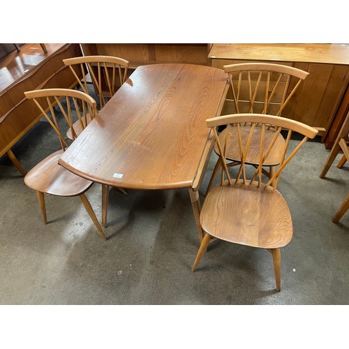 27 - An Ercol Blonde elm and beech Windsor drop-leaf table and four candlestick back chairs