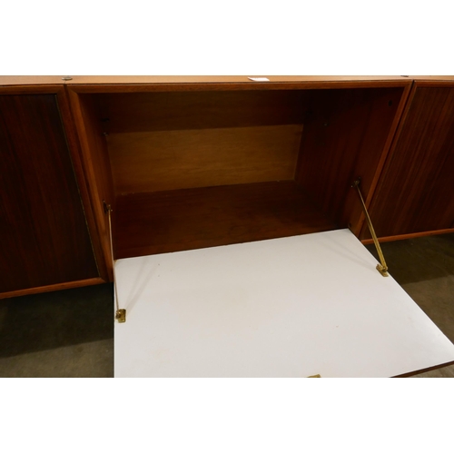 68 - A tola wood fitted three door sideboard