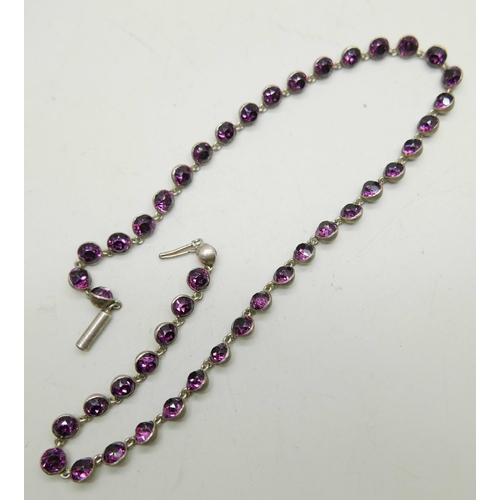 982 - A white metal necklace set with purple paste stones, 39cm