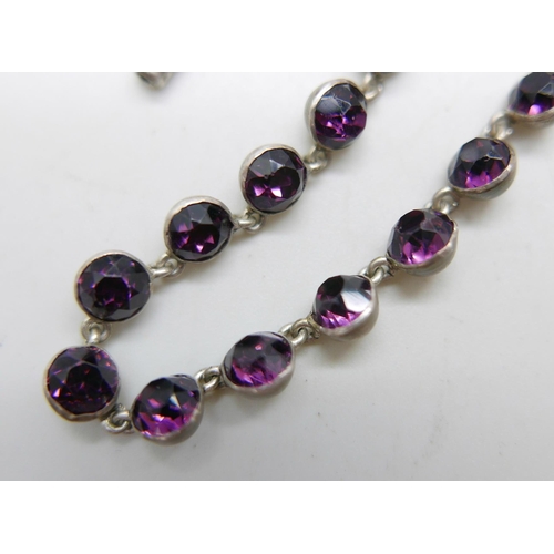 982 - A white metal necklace set with purple paste stones, 39cm