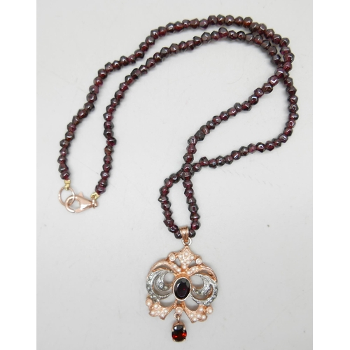 992 - A silver rose gold gilt and stone set pendant on a bead necklace with a silver gilt clasp, 28g total