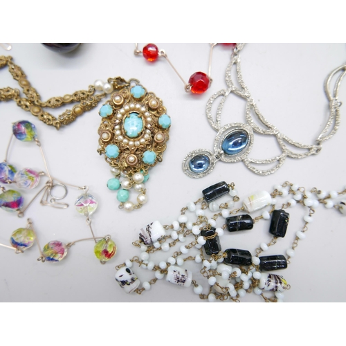 996 - Seven vintage costume necklaces including glass beads, and a decorative pendant