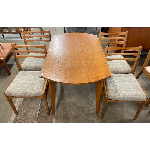 99 - A teak drop-leaf table and four chairs