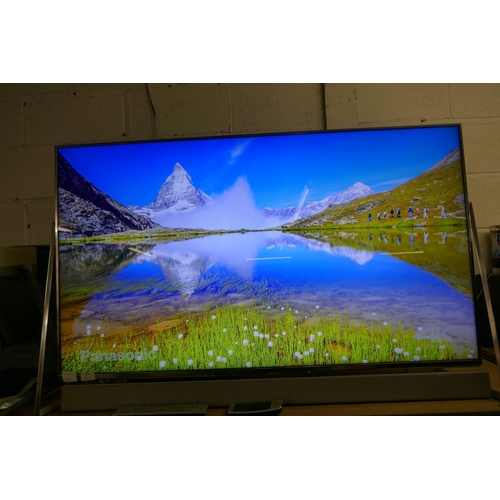 2113 - A Panasonic Smart 50” 4K UHD TV (TX-50DX802B) with sound bar and 2 remote controls