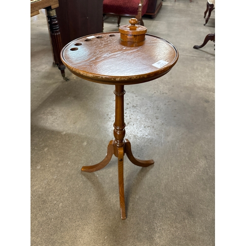 199 - A Victorian style oak tripod smoking table