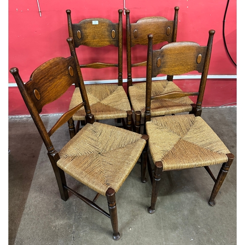 150 - A set of four William Birch Arts and Crafts oak dining chairs