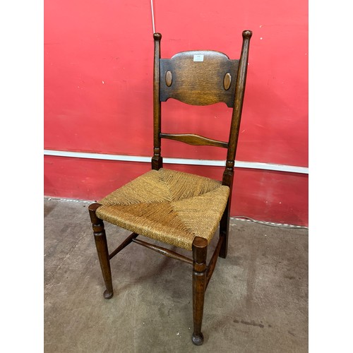 150 - A set of four William Birch Arts and Crafts oak dining chairs