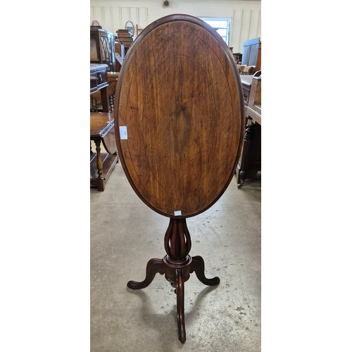 206 - A Victorian mahogany oval tilt top tripod table