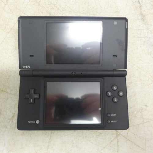 2083 - A boxed matte black Nintendo DSi with charger and two games including Cooking Guide and More Brain T... 