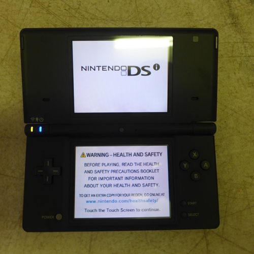 2083 - A boxed matte black Nintendo DSi with charger and two games including Cooking Guide and More Brain T... 