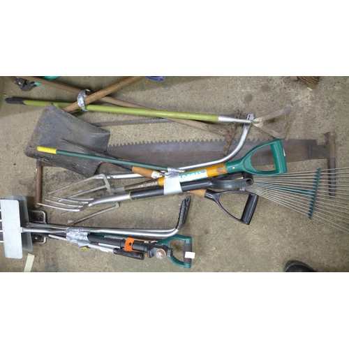 2182 - A large quantity of garden tools, approx 20 items including forks, spades, pick axe, lump hammers, s... 