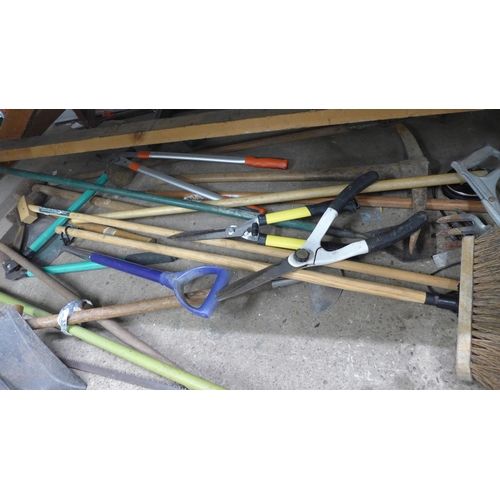 2182 - A large quantity of garden tools, approx 20 items including forks, spades, pick axe, lump hammers, s... 