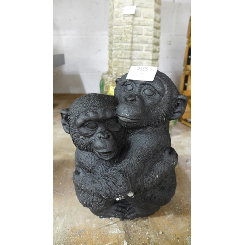 2195 - Two concrete garden ornaments of chimpanzees cuddling each other