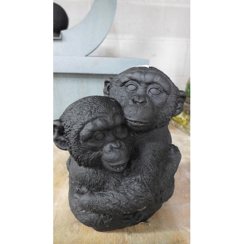 2195 - Two concrete garden ornaments of chimpanzees cuddling each other