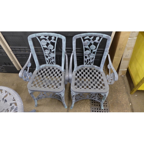 2228 - A grey plastic cast iron effect garden table and 2 chairs