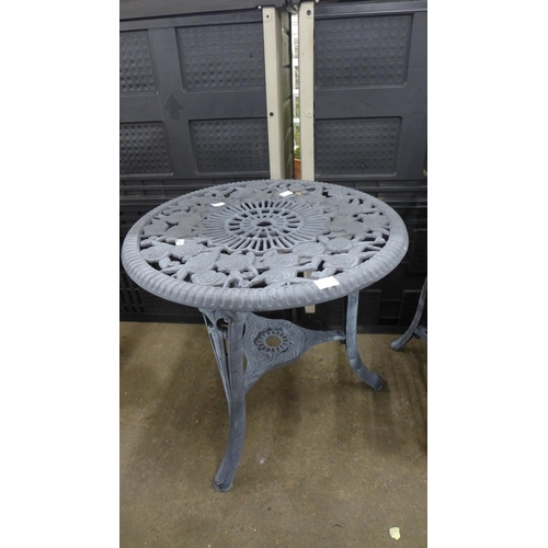 2228 - A grey plastic cast iron effect garden table and 2 chairs