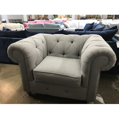 1400 - A grey upholstered Chesterfield love seat RRP £1299