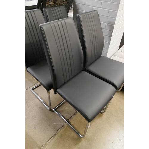 1416 - A set of four black & chrome dining chairs *This lot is subject to VAT