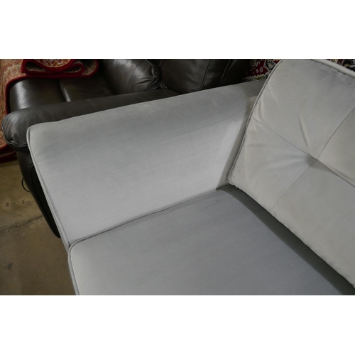 1438 - A pewter velvet three seater sofa