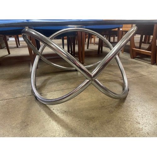 62 - A chrome and glass topped circular coffee table