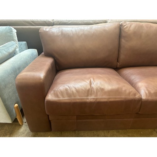 1444 - A Brown upholstered three seater sofa