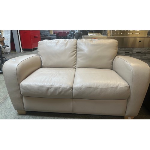 1509 - A beige leather two seater sofa